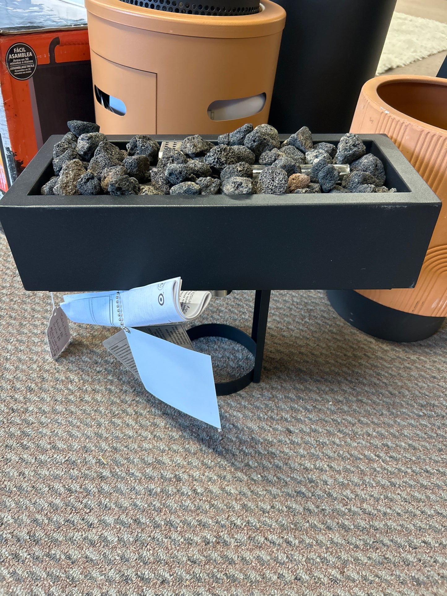 Fire pit attaches through umbrella hole of any outdoor table- requires 1 lb propane tank ($7.99 at Ace Hardware), which mounts under the table. Retails for $80.
