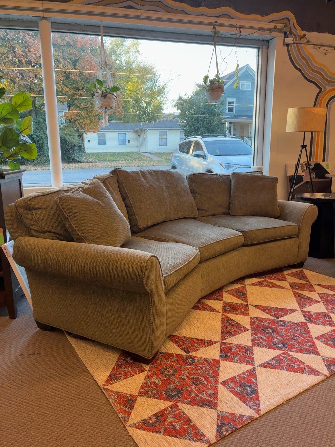 Taupe curved back sofa in fair condition