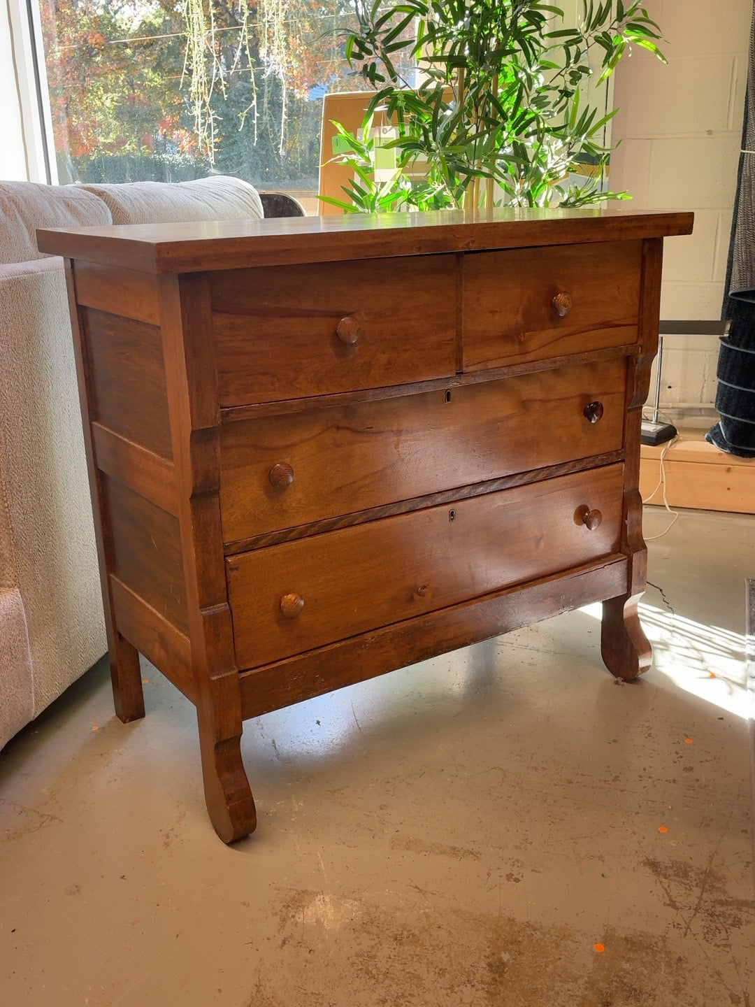 Antique brown wooden four-drawer dresser