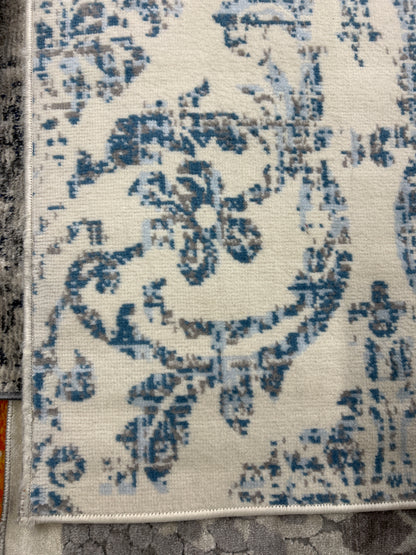 8 x 10 ivory and blue area rug ￼- as is (minor fraying on some edges)