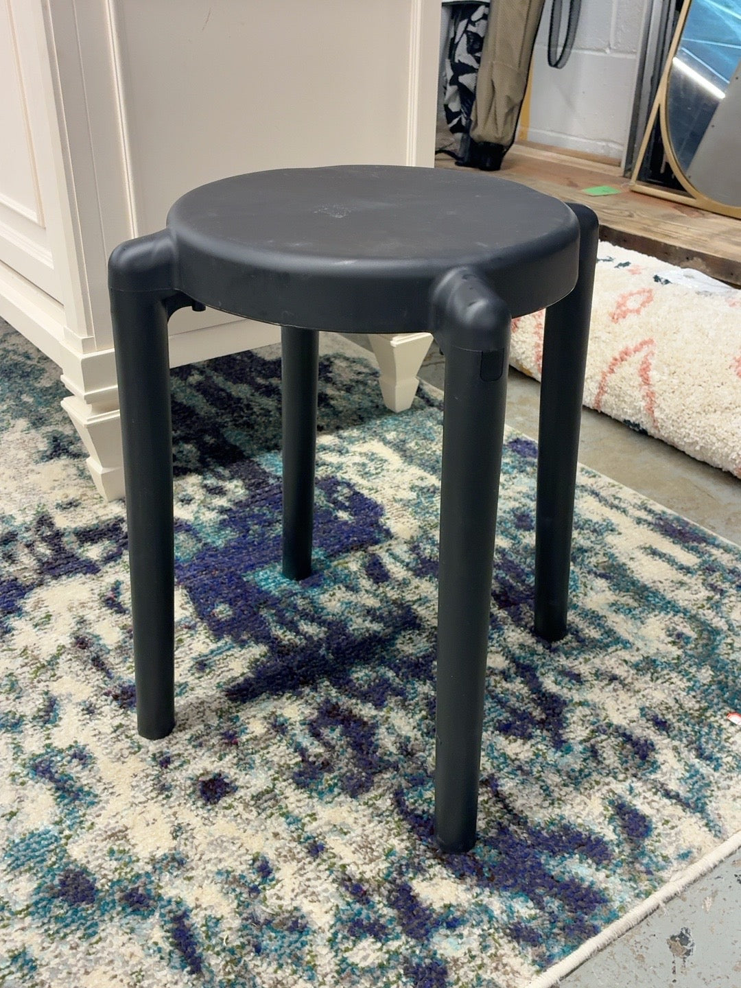 Black round four leg stool