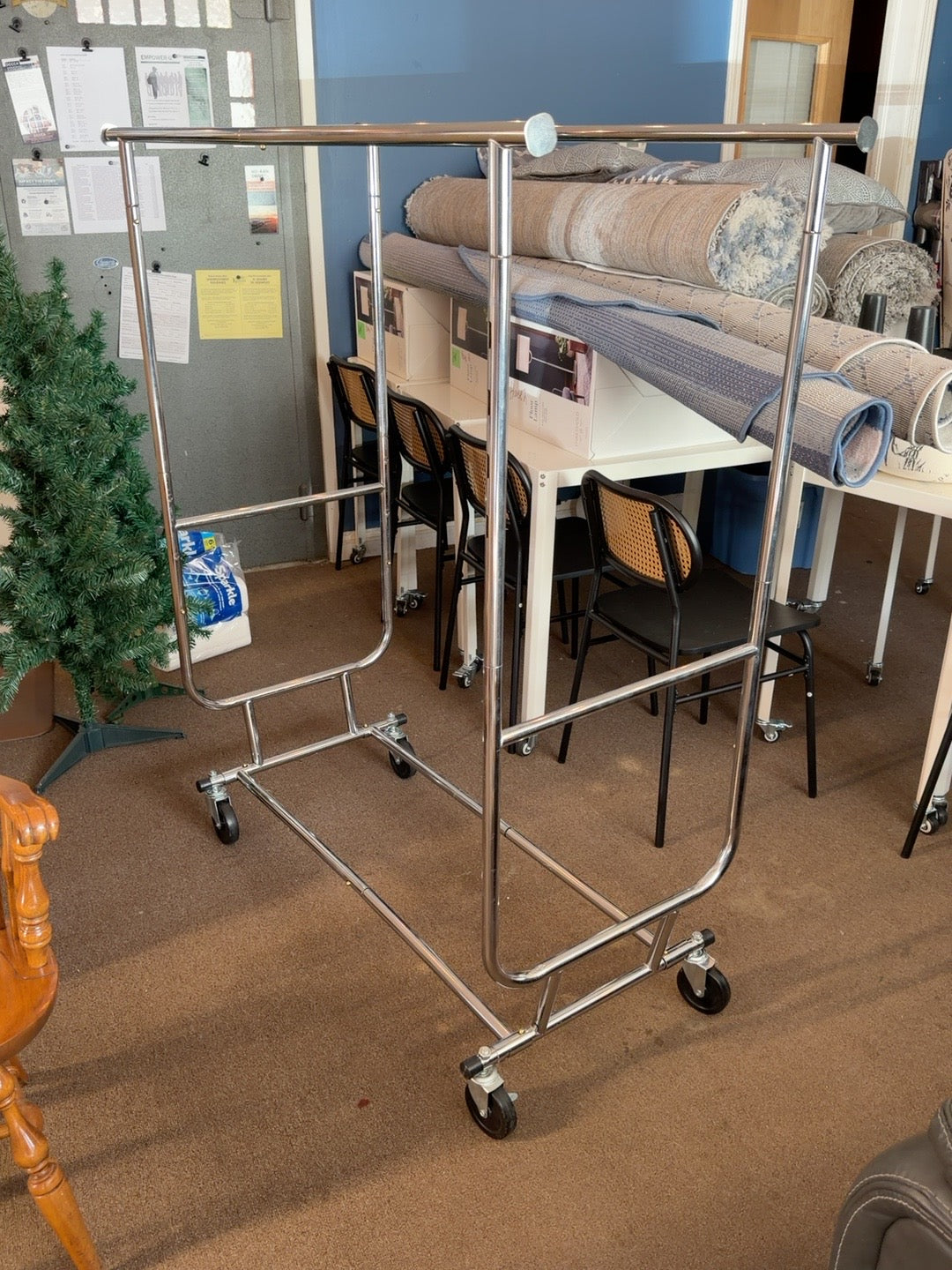 Donated chrome double-rail rolling clothes rack