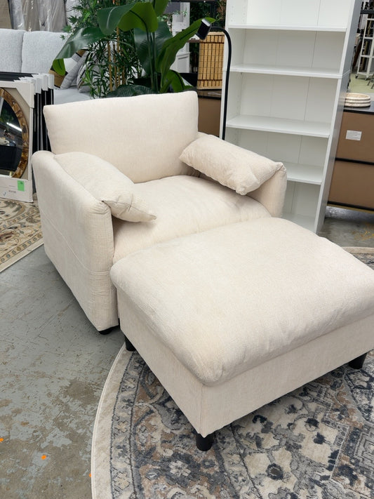 Beige upholstered ModernLuxe lounge chair with pillow armrests, flexible phone holder, and matching ottoman photographed in the Ready For Good furniture store