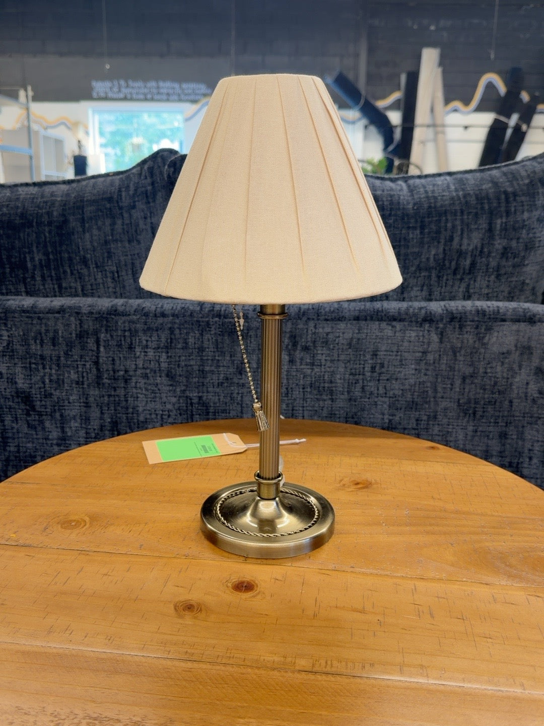 Antique brass tone table lamp with pleated cream shade