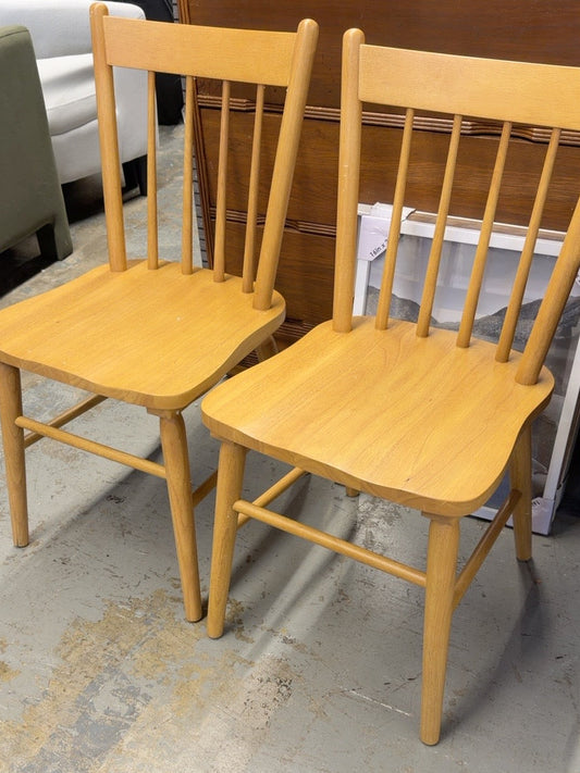 Pair of natural wood Threshold Hassell dining chairs with spindle backs, shown together at Ready For Good