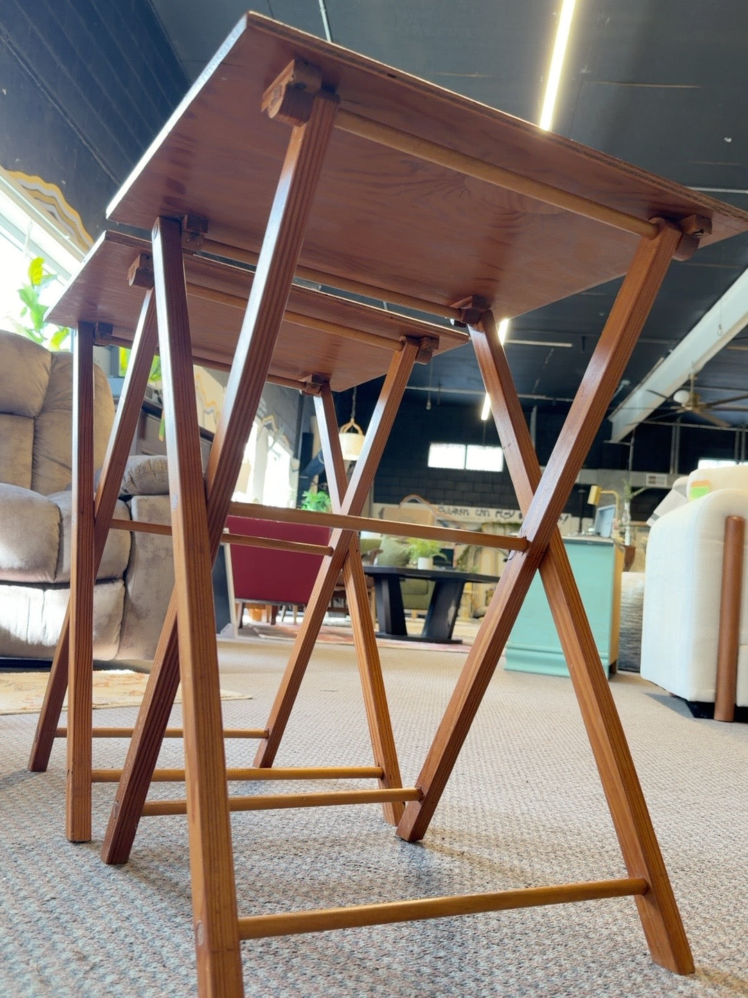 Underside and wooden folding frames of two TV tray tables