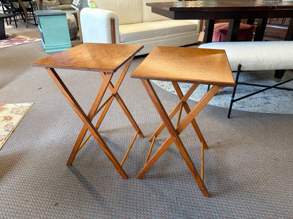 Pair of honey brown wooden folding TV tray tables with visible finish wear